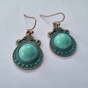 These bronze earrings featuring a marble drop center and intricate bronzed detail