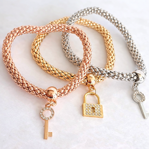 Three-tone charm bracelet set with rose gold gold and silver bracelets featuring key and lock charms from Stella’s Earrings in Moreletapark Pretoria East South Africa