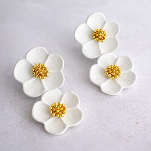 White flower stud earrings with gold centre detail from Stella’s Earrings in Moreletapark Pretoria East South Africa